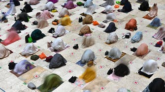 Muslims in Indonesia open Ramadan with social distanced prayers, vaccines