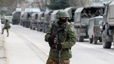 Armed servicemen wait in Russian army vehicles outside a Ukranian border guard post in the Crimean town of Balaclava. (File Photo: Reuters)