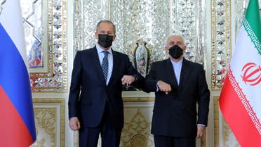 Iran’s Foreign Minister Mohammad Javad Zarif and Russia’s Foreign Minister Sergei Lavrov bump elbows while meeting in Tehran, Iran. (Reuters)