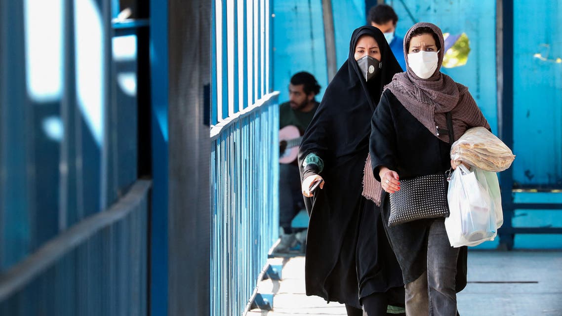 People wearing protective masks amid the coronavirus pandemic walk on a street in Iran's capital Tehran, on April 5, 2021. Iran's daily new COVID-19 infections reached a four-month high, said the health ministry, as the capital Tehran was put on the highest virus risk level.