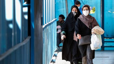 People wearing protective masks amid the coronavirus pandemic walk on a street in Iran's capital Tehran, on April 5, 2021. Iran's daily new COVID-19 infections reached a four-month high, said the health ministry, as the capital Tehran was put on the highest virus risk level.