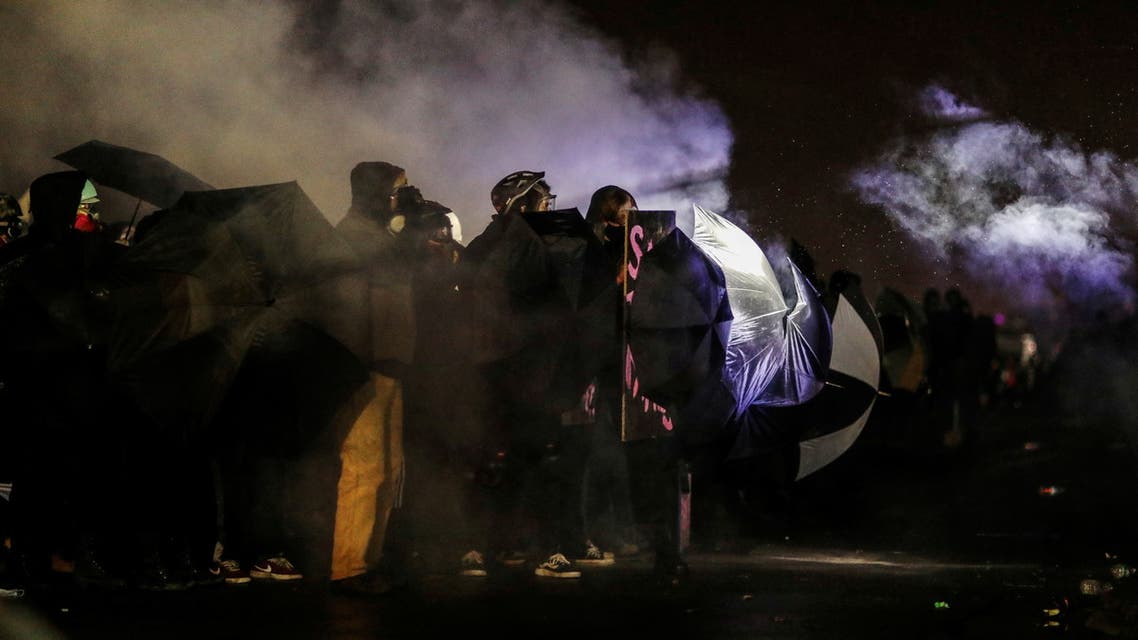 Protesters rally outside the Brooklyn Center Police Department, as it is guarded by law enforcement and the National Guard, days after Daunte Wright was shot and killed by a police officer, in Brooklyn Center, Minnesota, U.S. April 13, 2021. REUTERS/Leah Millis
