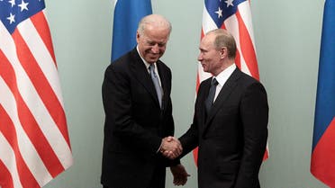 Russian Prime Minister Vladimir Putin (R) shakes hands with then-US VP Joe Biden (L) on March 10, 2011 during their meeting in Moscow. (AFP)