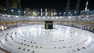 Muslim worshippers gather for prayers around the Kaaba, the holiest shrine in the Grand mosque complex in the Saudi city of Mecca during the first day of the Muslim holy fasting month of Ramadan on April 13, 2021. (AFP)
