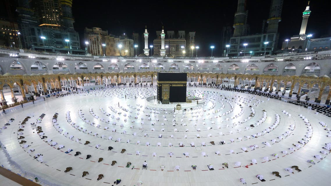 Muslim worshippers gather for prayers around the Kaaba, the holiest shrine in the Grand mosque complex in the Saudi city of Mecca during the first day of the Muslim holy fasting month of Ramadan on April 13, 2021. (AFP)
