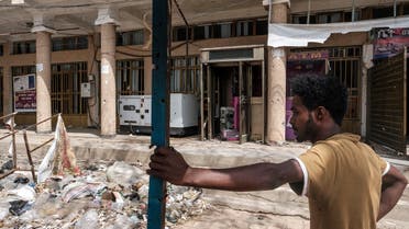 A man stands in front of a bank which was allegedly looted by Eritrean forces, in Wukro, north of Mekele, on March 1, 2021. (AFP)