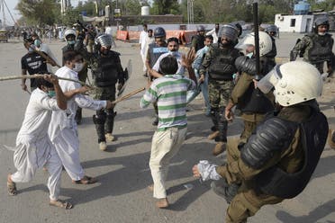 Policemen beat a supporter of Tehreek-e-Labbaik Pakistan (TLP) party during a protest against the arrest of their leader as he was demanding the expulsion of the French ambassador over depictions of Prophet Muhammad, in Lahore on April 13, 2021. (AFP)