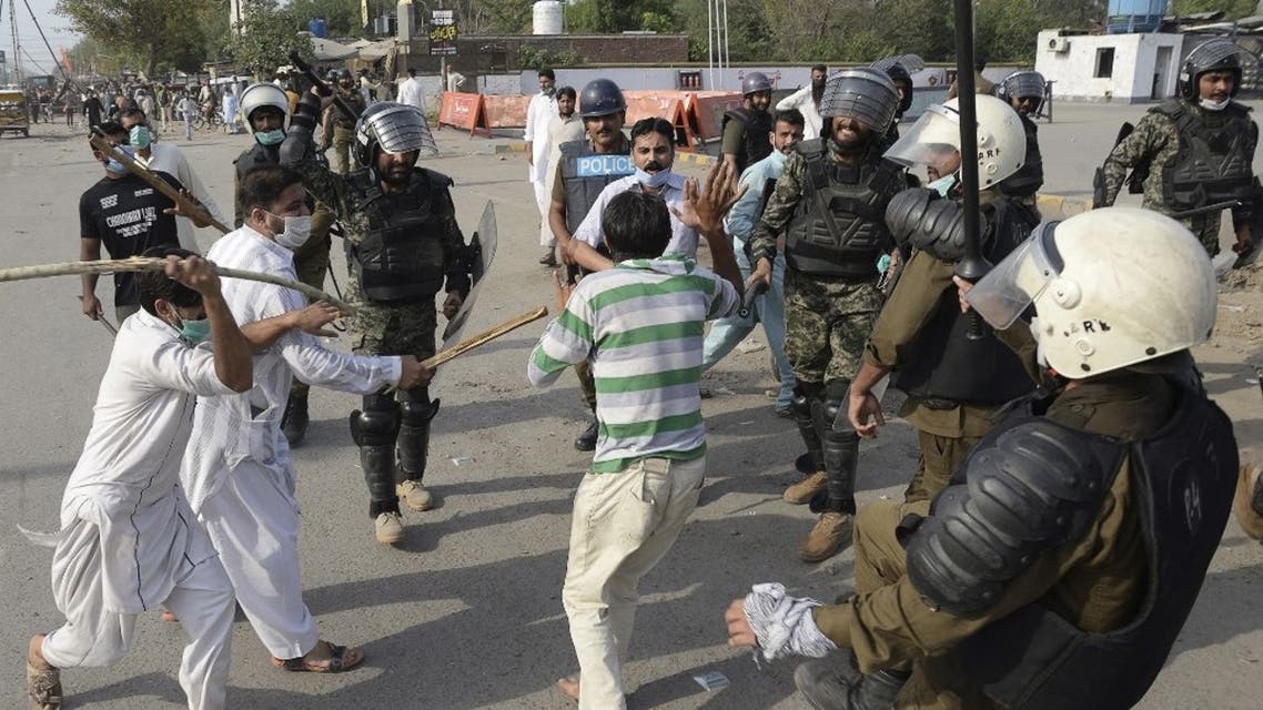 Policemen beat a supporter of Tehreek-e-Labbaik Pakistan (TLP) party during a protest against the arrest of their leader as he was demanding the expulsion of the French ambassador over depictions of Prophet Muhammad, in Lahore on April 13, 2021. (AFP)
