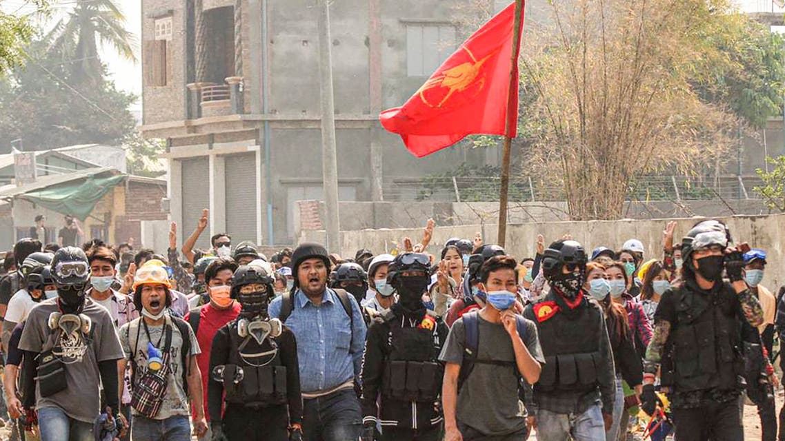 This photo taken and received from an anonymous source via Facebook on April 3, 2021 shows activist Wai Moe Naing (C in blue) walking with protesters during a demonstration against the military coup in Monywa, Sagaing region. (AFP)