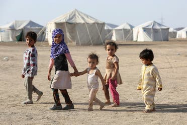 Children walk at a camp for people recently displaced by fighting between government forces and Houthis, in Marib, Yemen March 8, 2020. (Reuters)