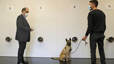 Lebanese doctor Riad Sarkis (L) supervises the training process of a COVID-19 sniffer dog at a facility in Lebanon's capital Beirut on February 18, 2021. (AFP)