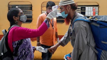 FILE PHOTO: A health worker checks a passenger's temperature and pulse at a railway station platform amidst the spread of the coronavirus disease (COVID-19) in Mumbai, India, April 7, 2021. (File Photo: Reuters)
