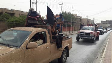 ISIS terrorists celebrate on vehicles taken from Iraqi security forces, at a street in city of Mosul, June 12, 2014. (Reuters)