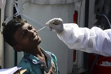 A health worker takes a swab sample from a youth for a RT-PCR Covid-19 coronavirus test at a bus terminus in Chennai on March 22, 2021. (AFP)