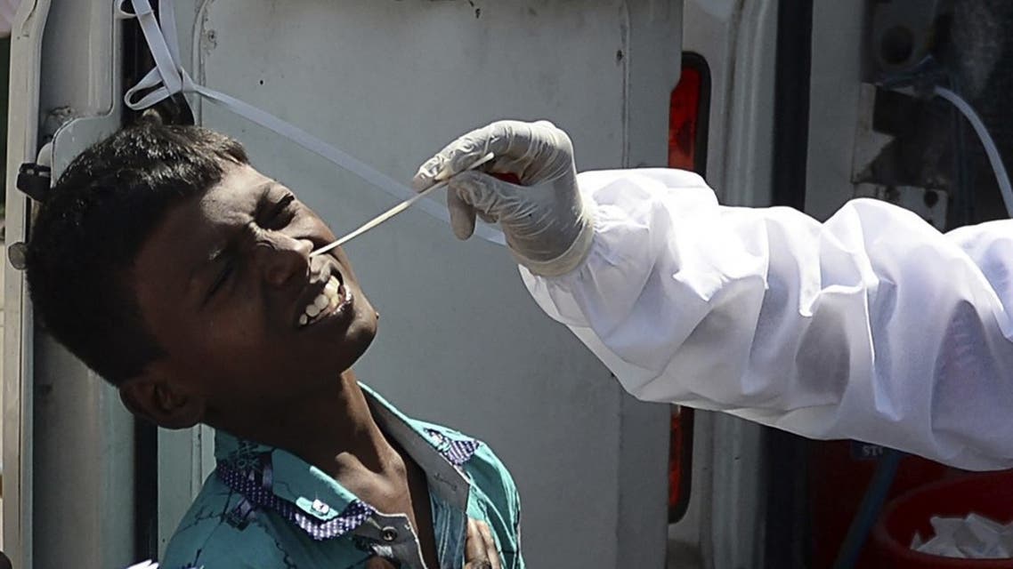 A health worker takes a swab sample from a youth for a RT-PCR Covid-19 coronavirus test at a bus terminus in Chennai on March 22, 2021. (AFP)