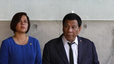 The President of the Philippines Rodrigo Duterte looks on as he sits next to his daughter (L) on September 3, 2018. (AFP)