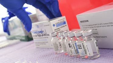 Bottles of the single-dose Johnson & Johnson Janssen Covid-19 vaccine await transfer into syringes for administering at a vaccine rollout targetting immingrants and the undocumented in Los Angeles, California on March 25, 2021. (AFP)