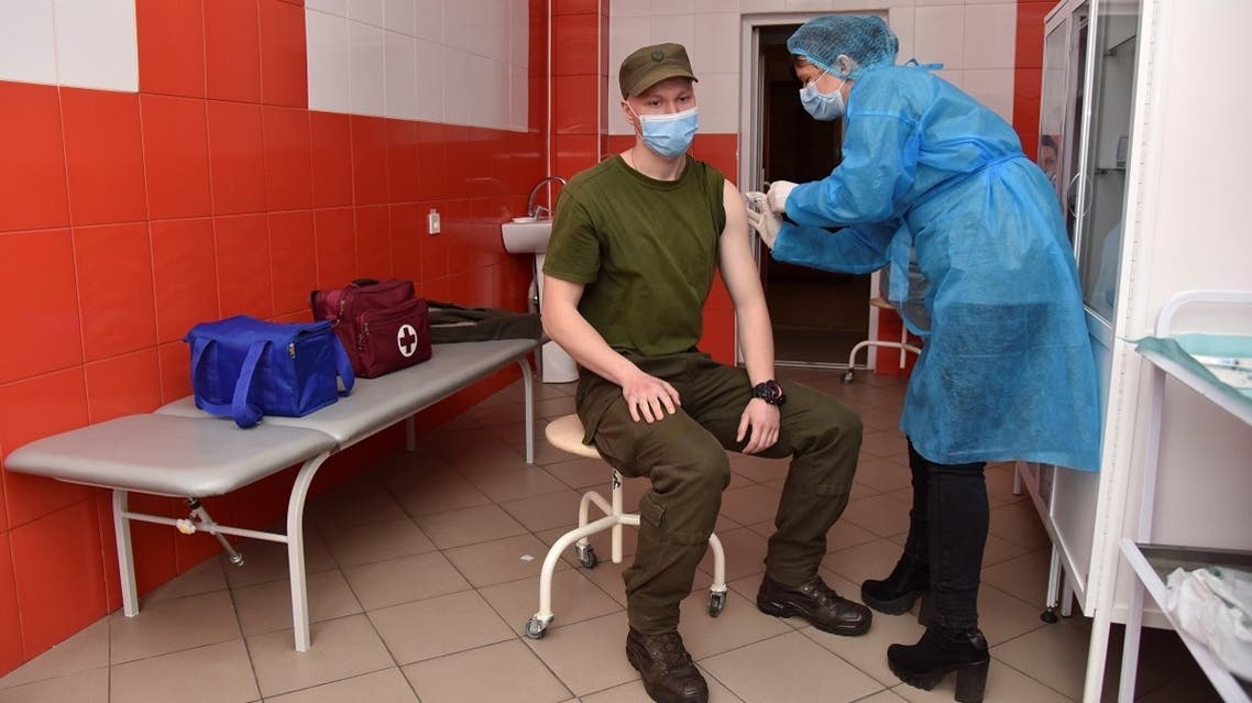 A member of the Ukrainian National Guard receives a dose of the Oxford University/AstraZeneca vaccine against the coronavirus in Lviv, Ukraine, on April 14, 2021. (Reuters)