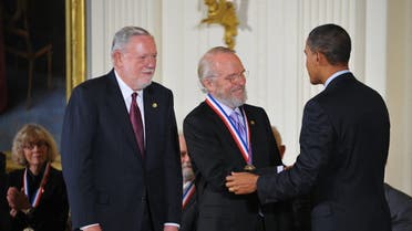US President Barack Obama presents a National Medal of Technology and Innovation to John E. Warnock (C) and Charles M. Geschke (L) of Adobe Systems Inc. (AFP)