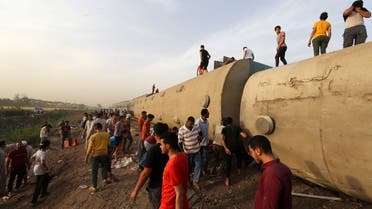 People gather at the site where train carriages derailed in Qalioubia province, north of Cairo, Egypt April 18, 2021. REUTERS/Mohamed Abd El Ghany TPX IMAGES OF THE DAY
