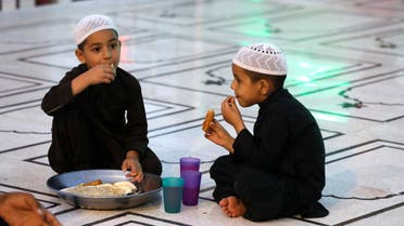 Boys have their Iftar (breaking fast) meal during the fasting month of Ramadan at a mosque in Karachi. (Reuters)