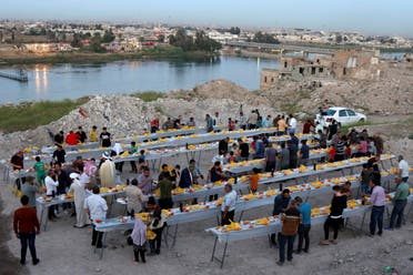 People gather to have their Iftar (breaking fast) meals during the fasting month of Ramadan, in Mosul, Iraq. (Reuters)