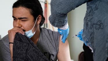 Cristian Ramírez grimaces while receiving his coronavirus disease (COVID-19) vaccine at a rural vaccination site in Columbus, New Mexico, U.S., April 16, 2021. REUTERS/Paul Ratje