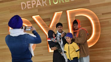 A family takes photos before their flight for New Zealand at Sydney International Airport on April 19, 2021, as Australia and New Zealand opened a trans-Tasman quarantine-free travel bubble. (File photo: AFP)