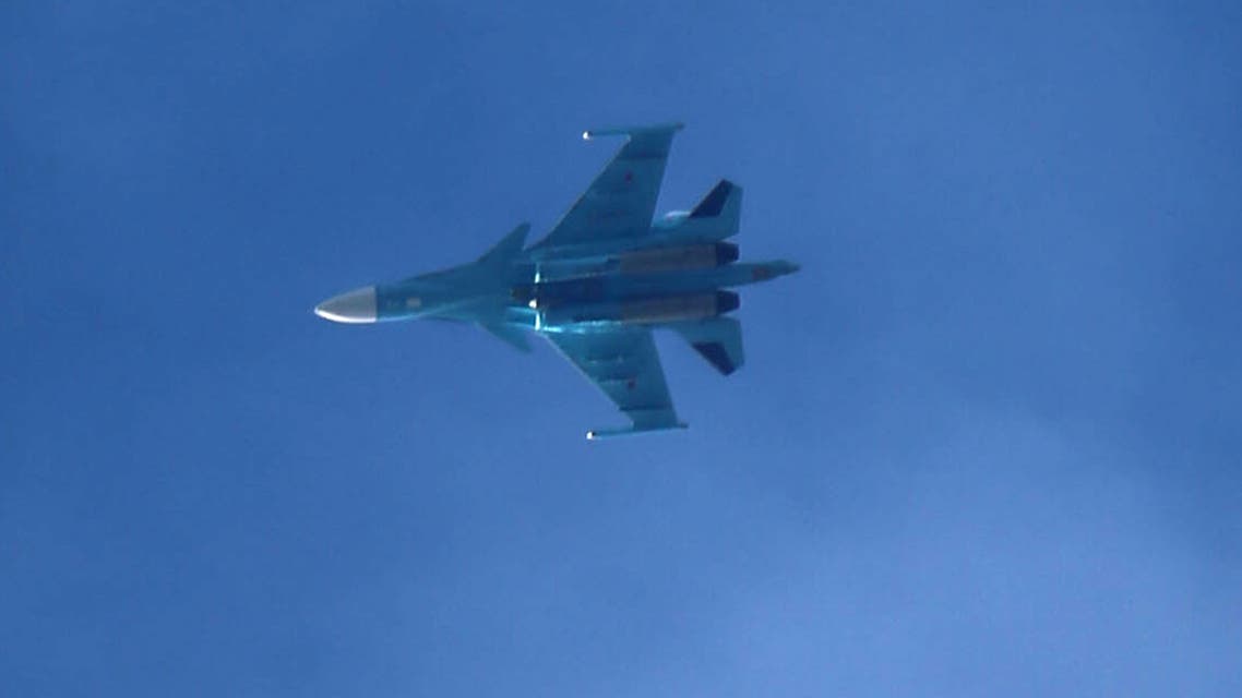 A picture taken on February 20, 2018 shows a Russian air force Sukhoi Su-34 fighter jet flying over the sky in the rebel-held town of Arbin, in the besieged Eastern Ghouta region on the outskirts of the capital Damascus.