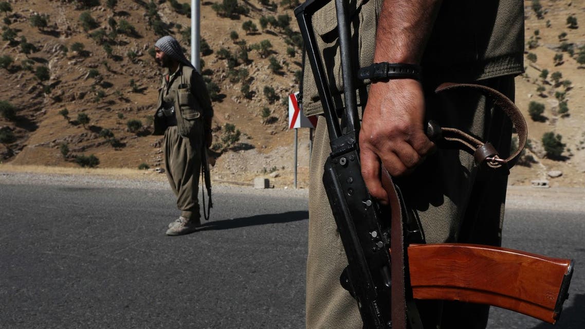 A member of the Kurdistan Workers' Party (PKK) carries an automatic rifle on a road in the Qandil Mountains, the PKK headquarters in northern Iraq, on June 22, 2018. (AFP)