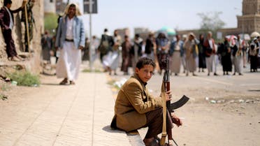 A boy holds a rifle as he sits at the site of a rally held by followers of the Shi'ite Houthi movement to commemorate the Ashura, the holiest day on the Shi'ite Muslim calendar, in Sanaa, Yemen August 30, 2020. REUTERS/Khaled Abdullah TPX IMAGES OF THE DAY
