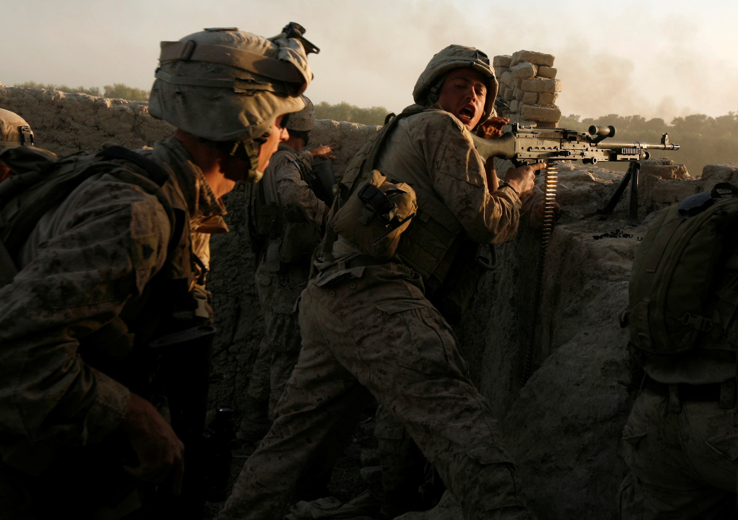 US Marines fire during a Taliban ambush as they carry out an operation to clear an area in Helmand province, Afghanistan, October 9, 2009. (Reuters)