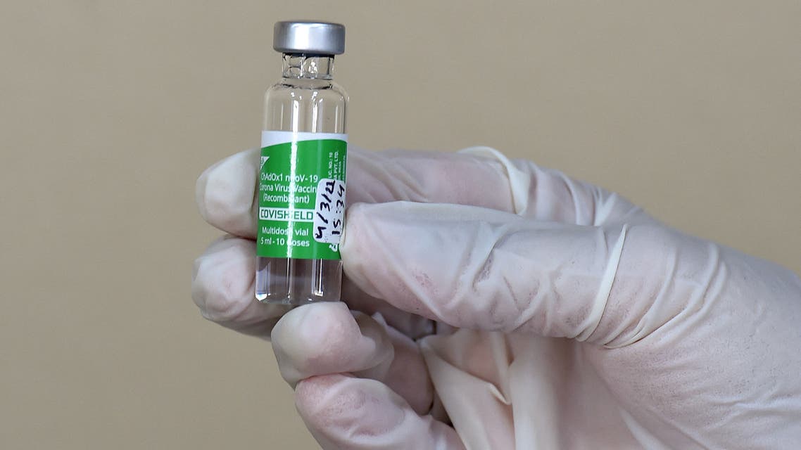 A medical worker displays a dose of the AstraZeneca COVID-19 vaccine at the first drive-through vaccination center in the Saudi capital Riyadh, on March 4, 2021.
