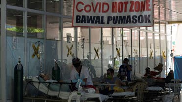 Suspected coronavirus disease (COVID-19) patients lie on hospital beds outside the emergency room of Amang Rodriguez Memorial Medical Center, in Marikina City, Metro Manila, Philippines. (Reuters)