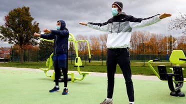 People wearing protective face masks train at an outdoor gym in Brussels. (File photo: Reuters)