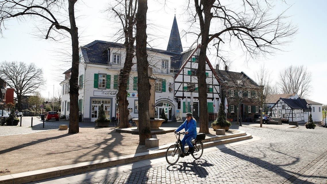 A man cycles through the North-Rhine Westphalian town of Monheim am Rhein, Germany, March 30, 2021. (Reuters)