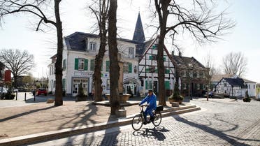 A man cycles through the North-Rhine Westphalian town of Monheim am Rhein, Germany, March 30, 2021. (Reuters)