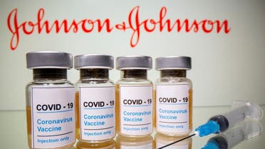 Vials and medical syringe are seen in front of a displayed Johnson & Johnson logo in this illustration taken October 31, 2020. (Reuters/Dado Ruvic)