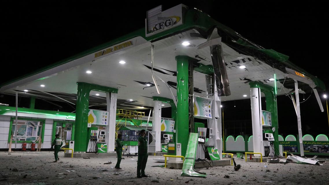 Gas station workers stand at the scene of a bomb attack in Kabul, Afghanistan, Wednesday, April 21, 2021. (AP)