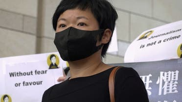 Bao Choy Yuk-Ling, a freelance journalist with RTHK, poses for pictures outside West Kowloon Magistrates' Courts as she arrives for charges of making a false statement to obtain data for a documentary on the police's handling of a mob attack, in Hong Kong, China April 22, 2021. (Reuters)