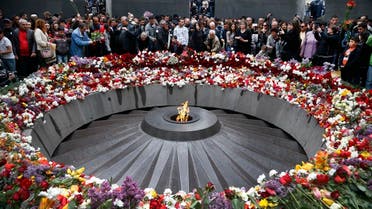 People lay flowers at a memorial to Armenians killed by the Ottoman Turks, as they mark the centenary of the genocide, in Yerevan, Armenia, April 24, 2015. (AP)