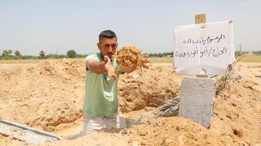 Palestinian worker Mohammad al-Haresh, 30, digs a grave for a coronavirus disease (COVID-19) victim, at a cemetery, east of Gaza City April 20, 2021. Picture taken April 20, 2021. (Reuters)