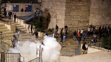 Palestinians run away as a stun grenade fired by Israeli police explodes during clashes at Damascus Gate just outside Jerusalem’s Old City, on the Muslim holy fasting month of Ramadan on April 17, 2021. (Reuters)