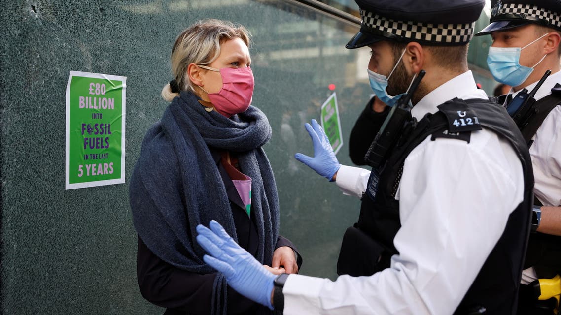Police officers detain an activist from the Extinction Rebellion, a global environmental movement, during a protest outside HSBC headquarters in Canary Wharf, London, Britain April 22, 2021. (Reuters)