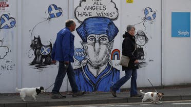 People are seen walking their dogs while passing a graffiti in support of the NHS, as the spread of the coronavirus disease (COVID-19) continues, Perth, Scotland, Britain, April 27, 2020. (File photo: Reuters)