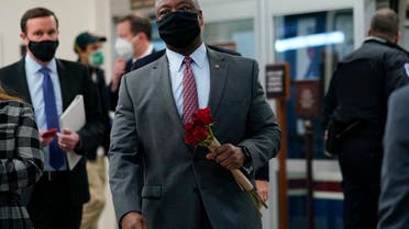 Sen. Tim Scott carries flowers as he walks on Capitol Hill, Feb. 12, 2021, on the fourth day of the second impeachment trial of former President Donald Trump. (AP)
