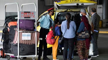 A porter loads the luggage of recently arrived air travelers from New Delhi, into a cab after Canada's government temporarily barred passenger flights from India and Pakistan for 30 days, at Vancouver International Airport in Richmond. (Reuters)