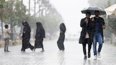 Men use an umbrella during rain in Riyadh, Saudi Arabia, February 16, 2017. REUTERS/Faisal Al Nasser