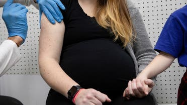 A pregnant woman receives a vaccine for the coronavirus disease (COVID-19) at Skippack Pharmacy in Schwenksville, Pennsylvania, U.S., February 11, 2021. REUTERS/Hannah Beier TPX IMAGES OF THE DAY