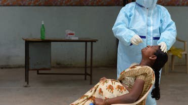 A health worker wearing Personal Protective Equipment (PPE) gear collects a swab sample of a pregnant woman at a free COVID-19 coronavirus testing centre at Medchal Malkajgiri district on the outskirts of Hyderabad on August 24, 2020. India's confirmed coronavirus cases crossed the three million mark on August 23 with nearly 70,000 new infections, as the disease continues to surge in the world's second most-populous nation.